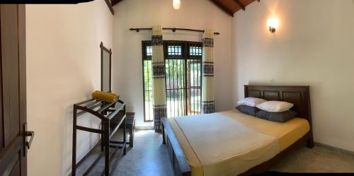 a bedroom with a bed and a staircase in it at Villa De Lagoon View in Tangalle