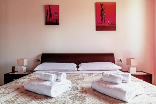 San SperateにあるCasa Azzurraのベッドルーム1室(ベッド2台、ベッド上にタオル付)