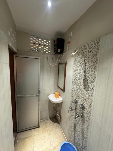 a bathroom with a shower and a sink at Hotel Punjab in Rourkela