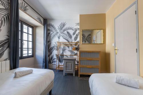 En eller flere senge i et værelse på Les marmousets, 5 minutes du Zoo