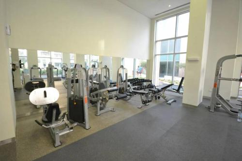 a gym with a large room with tread machines at City center with Burj View! in Dubai