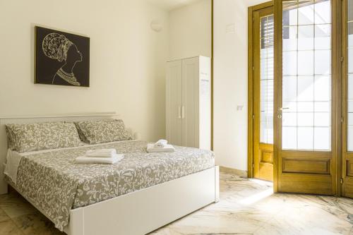 a bedroom with a bed with two towels on it at La Gemma del Salento Rooms&Apartments in Racale