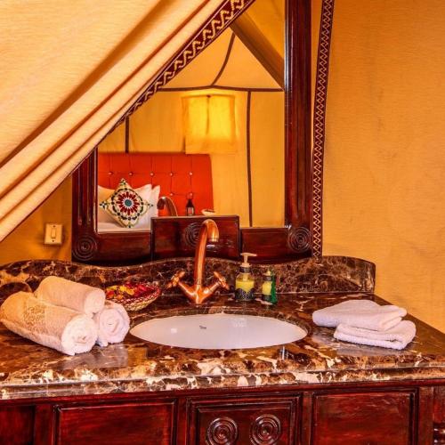 a bathroom with a sink and a mirror at marvelous luxury desert stars in Merzouga