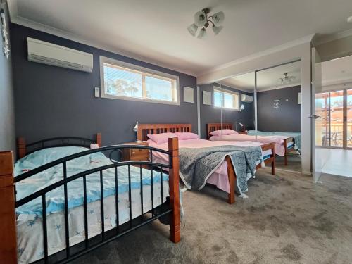 a bedroom with two bunk beds and a mirror at Breeza Haven - Your Home Away From Home in Kingston