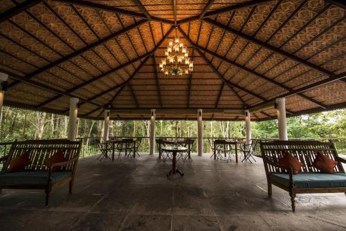 a large pavilion with tables and chairs and a chandelier at Pepper Trail in Sultan Bathery