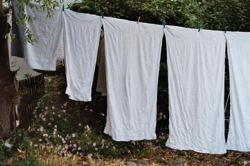 a group of white shirts hanging on a clothes line at Hotel Reingard in Wismar
