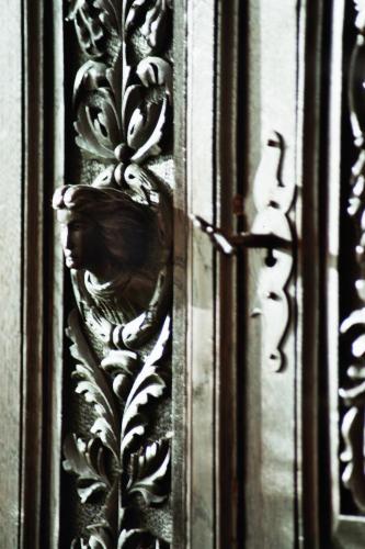 a wooden door with a bird on the side of it at Hotel Reingard in Wismar