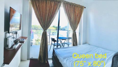 Una cama o camas en una habitación de Condo at Primavera city next to SM Mall