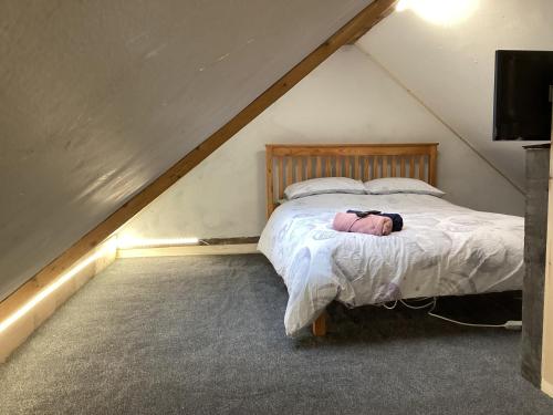 a bedroom with a bed in a attic at Barn 5 in Vigo Village