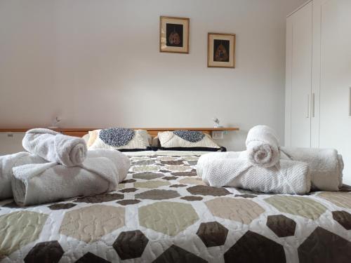 a bedroom with two beds with towels on them at Le Sorgenti Guest House in Ilbono