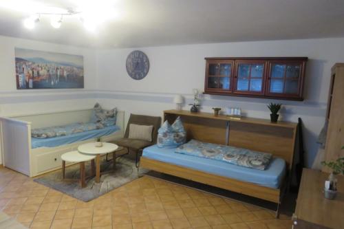 Cette chambre comprend 2 lits et une table. dans l'établissement Ferienwohnung mit Terrasse in Schellhorn, à Schellhorn