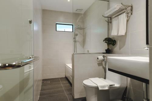 a white bathroom with a sink and a toilet at Pangkor Sandy Beach Resort in Pangkor