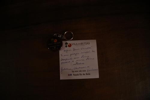 a piece of paper with a key chain on it at Pousada Vila dos Butias in Urubici