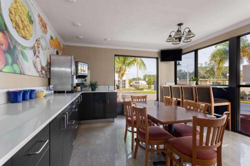 a kitchen with a table and chairs and a dining room at Days Inn by Wyndham St. Petersburg Central in St. Petersburg