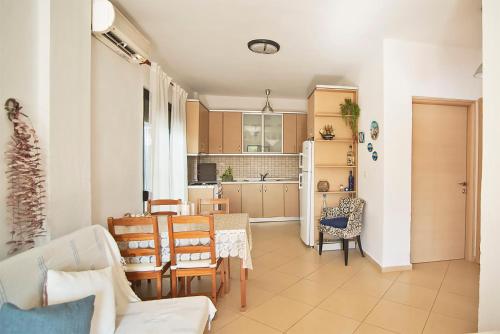 a kitchen and dining room with a table and chairs at Dorothy's house in Nea Plagia