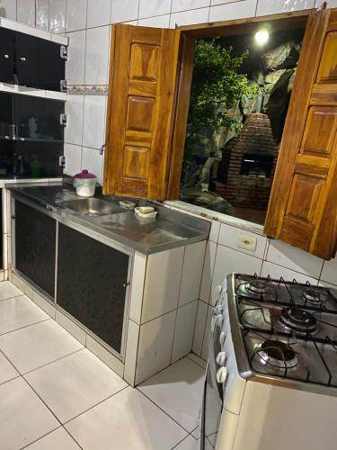 a kitchen with a sink and a stove in it at casa pedacinho do morro in Bom Jesus da Lapa