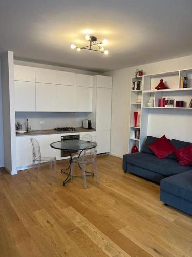 a living room with a table and a blue couch at Casa degli Ori by the city in Prato