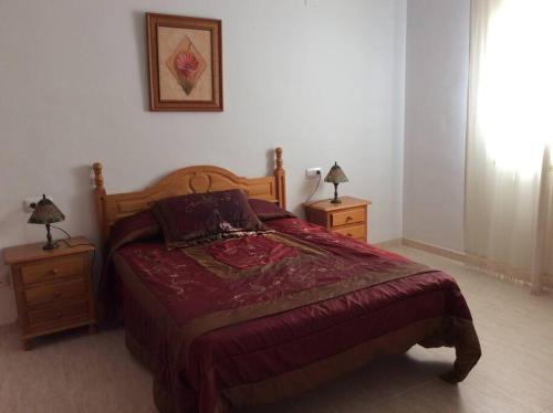 a bedroom with a bed and two night stands at Alojamientos el cuco Luque in Luque