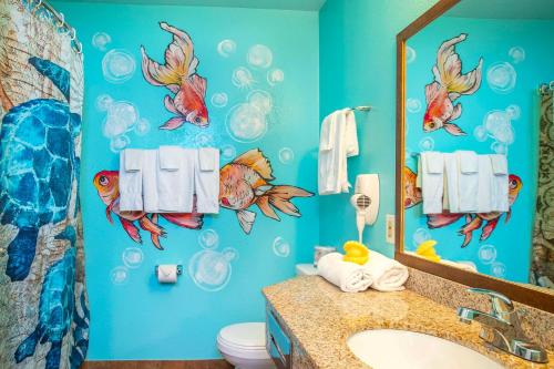 a bathroom with a fish mural on the wall at Quality Inn Winkler in Winkler