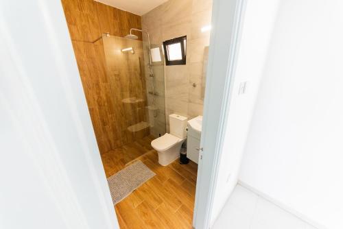 a small bathroom with a toilet and a shower at 2 bed, Kapparis, Trinidad - 2A in Paralimni