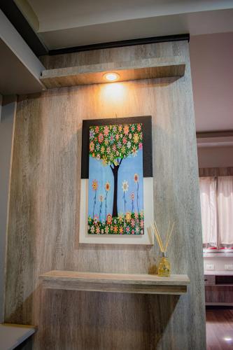 a painting of a tree with flowers on a wall at Hotel Rio Dorado in Encarnación