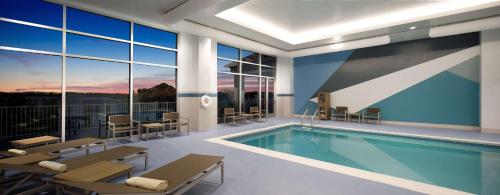 a swimming pool in a building with a view of the sky at Hyatt Place Kent Narrows And Marina in Grasonville