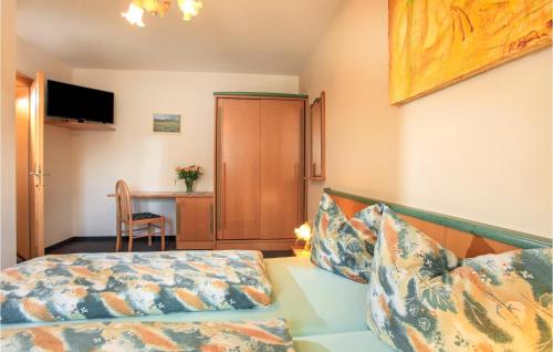 キルヒベルク・イン・チロルにあるAmazing Apartment In Kirchberg With 1 Bedrooms And Wifiのベッドルーム1室(ベッド1台、デスク、椅子付)