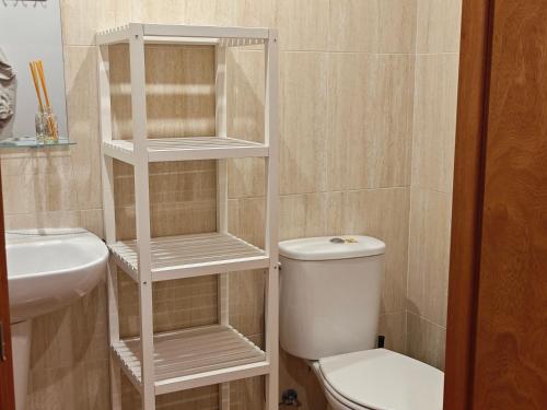 a bathroom with a white toilet and a sink at Cal Tuc in Camprodon