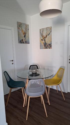 a dining room with a glass table and two chairs at כוכב הגלבוע in Gan Ner