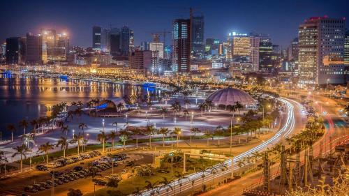 a city skyline at night with a busy street at A vista perfeita in Luanda