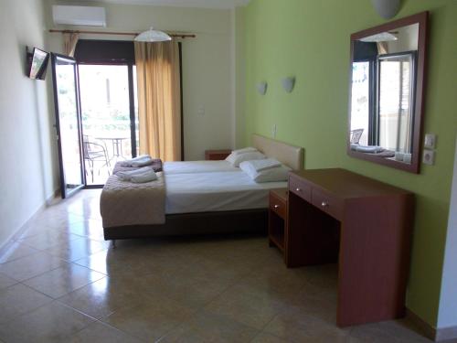 a bedroom with a bed and a mirror and a table at Oneiro Studios in Loutra Edipsou