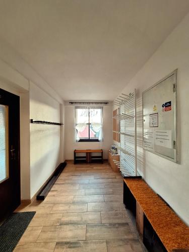 Cette chambre dispose d'un couloir avec une table et une fenêtre. dans l'établissement Apartmán 254, à Janské Lázně