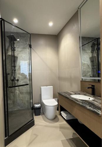 a bathroom with a toilet and a shower and a sink at Evropa Hotel in Bishkek