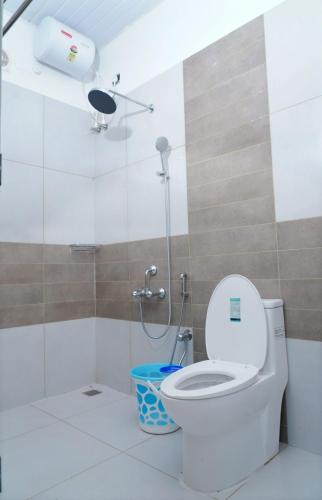 a bathroom with a toilet and a shower at Misty Bush Munnar in Munnar