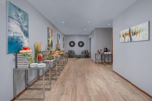 a hallway with tables with food on them at Four Points by Sheraton Dar es Salaam New Africa in Dar es Salaam