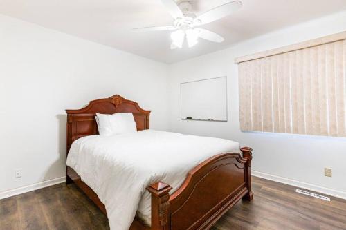 a bedroom with a bed with a ceiling fan at SmartHome- Omaha Homestay with EV Charging in Omaha