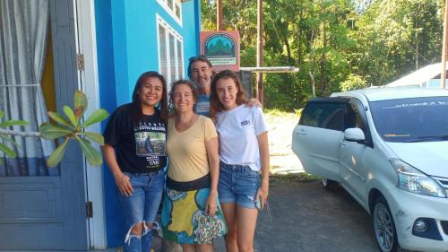 a group of people standing in front of a car at Tangkoko Gallery Guest House and Resto in Rinondoran