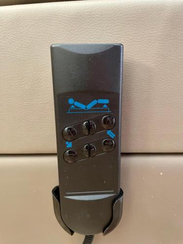 a black remote control with blue lights on it at Appartement Kastelo Teraso in Zalacsány