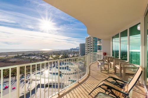 a balcony with chairs and a view of the beach at Caribe D814 in Orange Beach