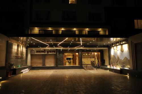 a store front at night with lights at Regenta Inn Morbi in Morbi