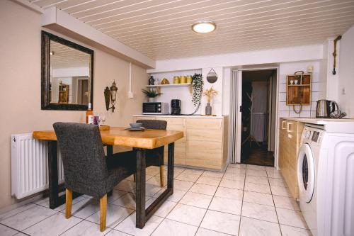 a kitchen with a table and chairs in a room at The Wine Cellar 