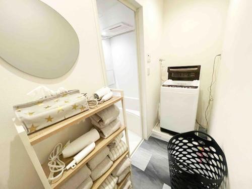 a bathroom with a mirror and a pile of towels at Holy Planet in Tokyo