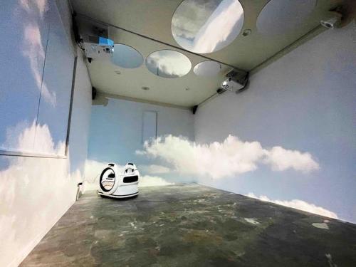 a room with a room with clouds in the sky at Holy Planet in Tokyo