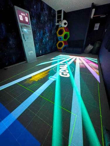 a room with neon lights on the floor at Holy Planet in Tokyo