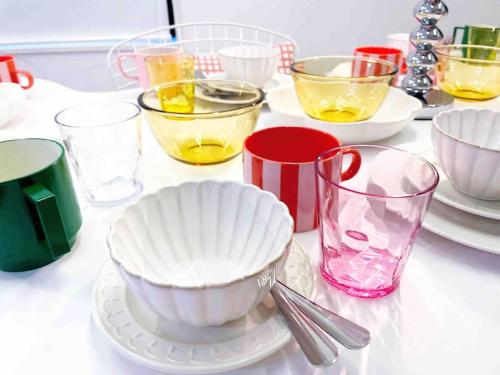 a table topped with plates and bowls and glasses at Holy Planet in Tokyo
