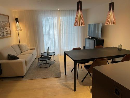 a living room with a couch and a table at Koller Sapuen by Arosa Holiday in Arosa