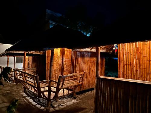 a couple of benches sitting in front of a building at Lionfish Backpackers Hostel Malapascua in Daanbantayan