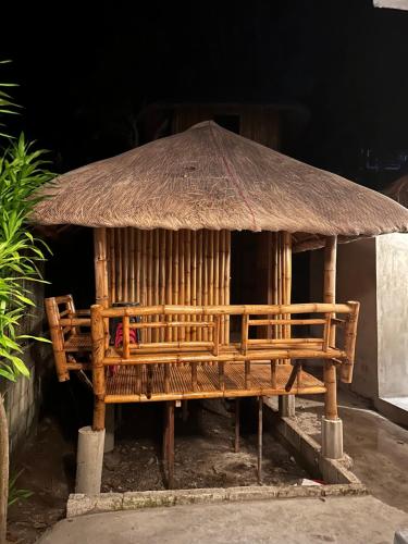 a wooden hut with a straw roof at Lionfish Backpackers Hostel Malapascua in Daanbantayan