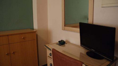 a television sitting on a desk in a room at Hotel Los Bartolos in Alhama de Murcia
