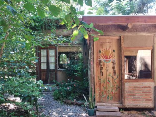 a building with a door with a painting on it at Eco Posada Tierra Fértil in Santa Ana